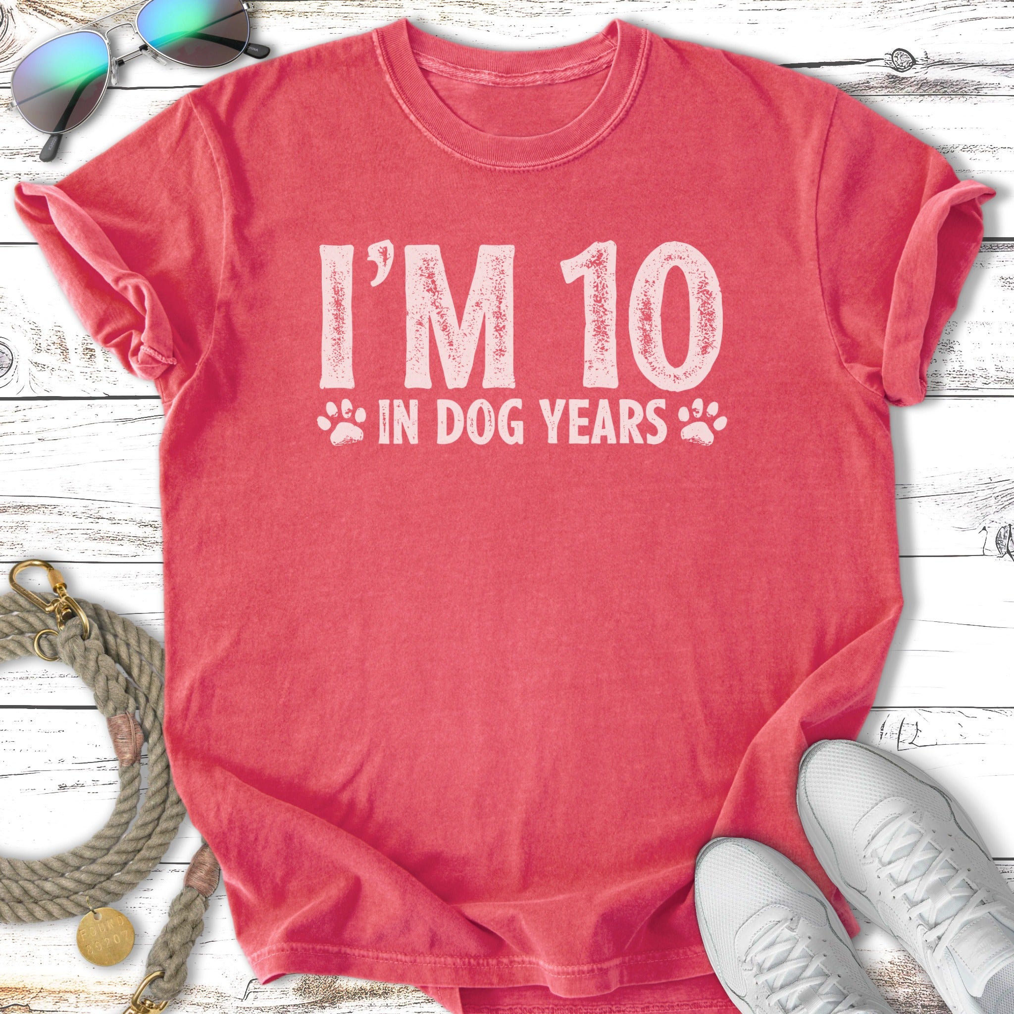 Salmon t-shirt with "I'M 10 IN DOG YEARS" text and paw print accents.