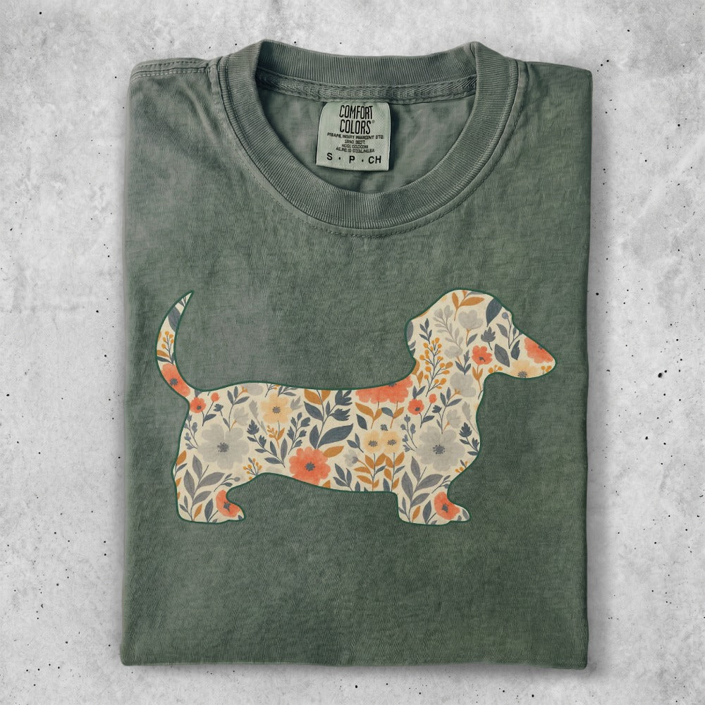 Green t-shirt with a dachshund silhouette filled with floral patterns.