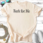 Cream t-shirt with "Bark for Me" text, dog leash, and sneakers.