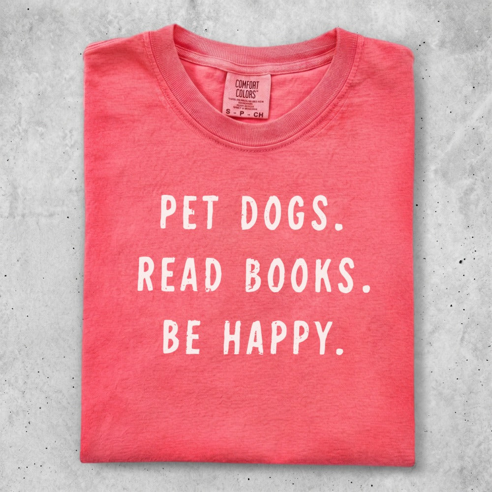 Red t-shirt with "PET DOGS. READ BOOKS. BE HAPPY." text.