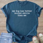 Blue t-shirt with white text that reads "my dog has better social skills than me".