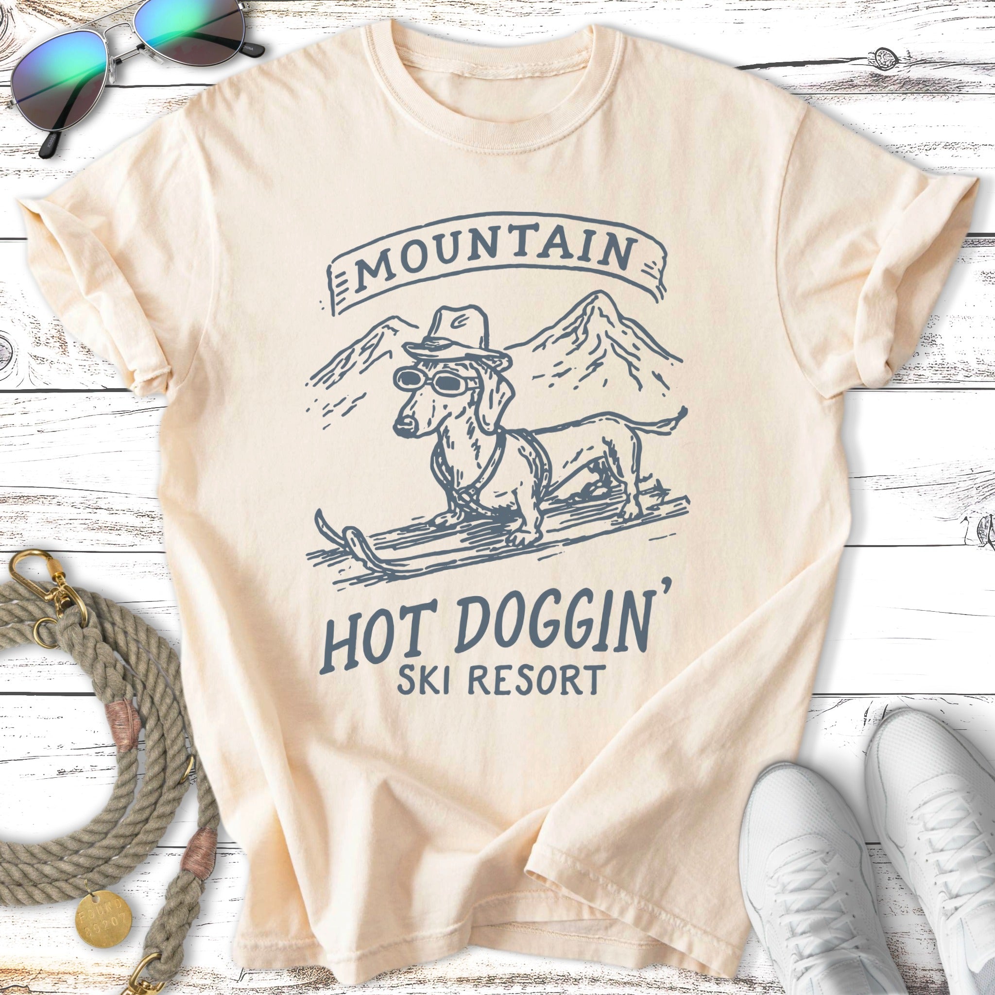 T-shirt with dachshund in sunglasses and hat on skis, text "Mountain Hot Doggin' Ski Resort".