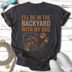 Dark gray t-shirt with "I'll be in the backyard with my dog" text and graphic.