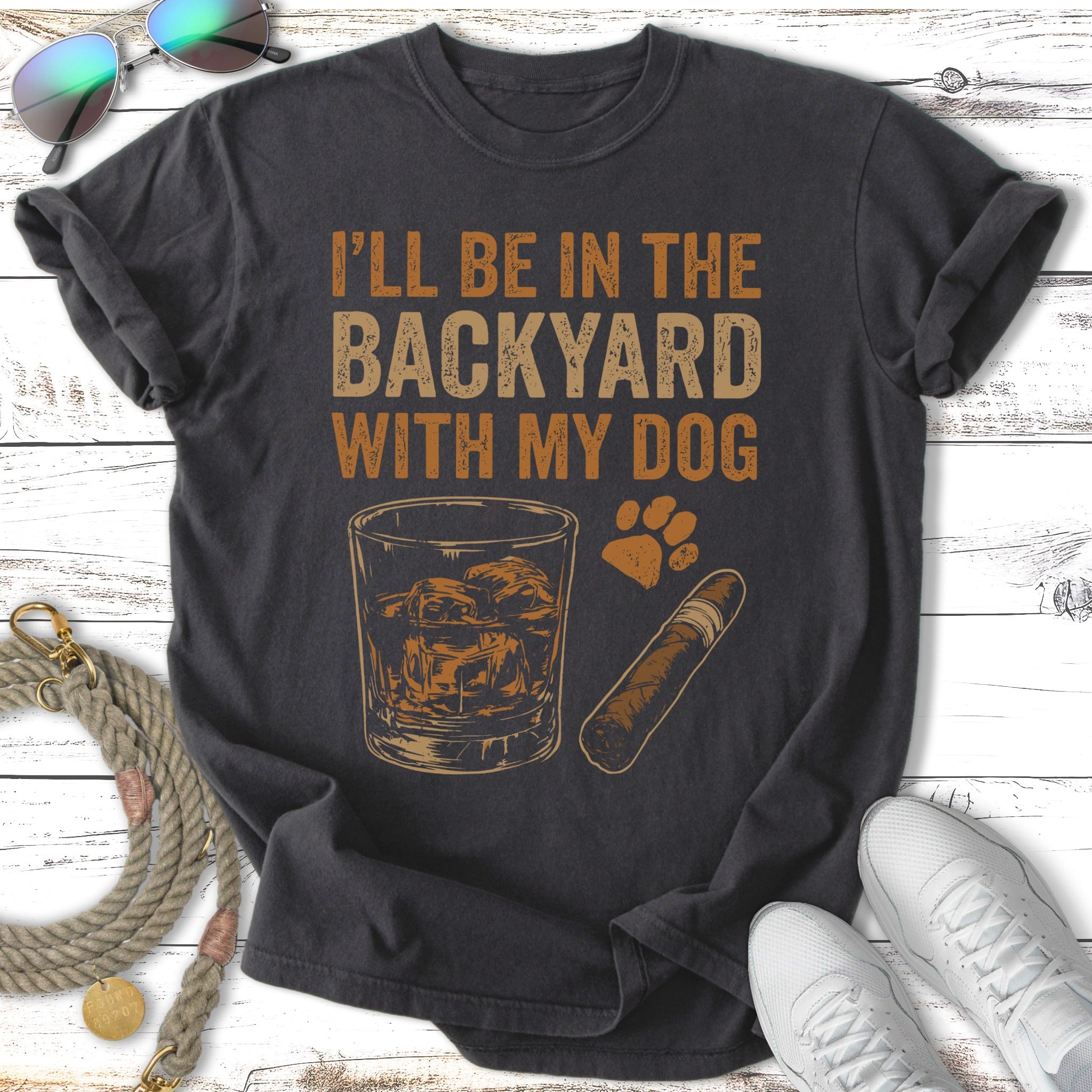 Dark gray t-shirt with "I'll be in the backyard with my dog" text and graphic.