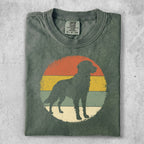 Silhouette of a dog in front of a circular, striped sunset graphic.