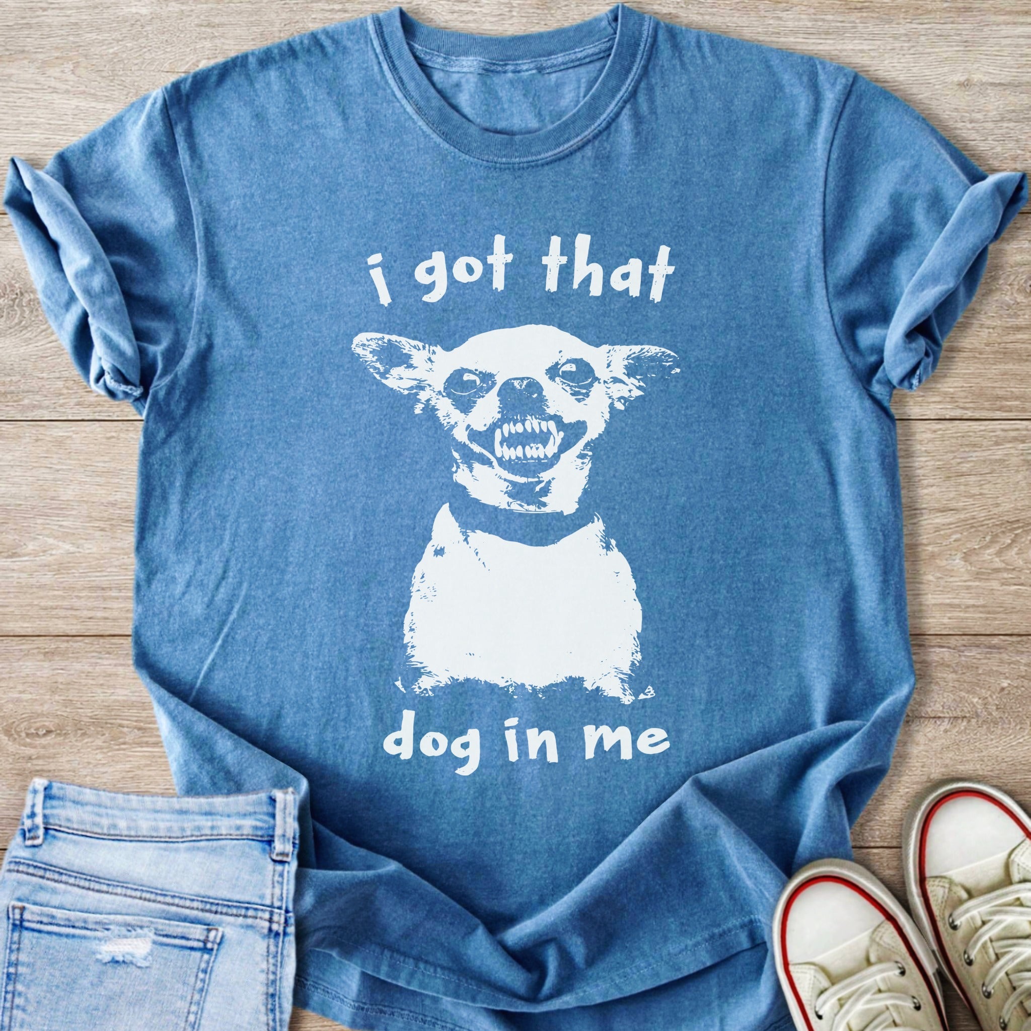 Blue t-shirt with white distressed graphic of a dog and text "i got that dog in me".