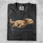 T-shirt with a sketched fluffy dog mid-leap over a puddle.