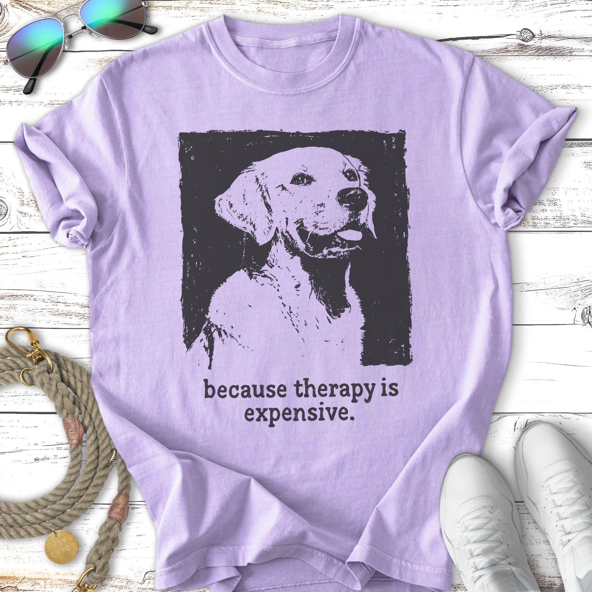 Labrador retriever portrait with "because therapy is expensive" text on a purple t-shirt.