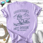 Dachshund in sunglasses on skis with "MOUNTAIN HOT DOGGIN' SKI RESORT" text.
