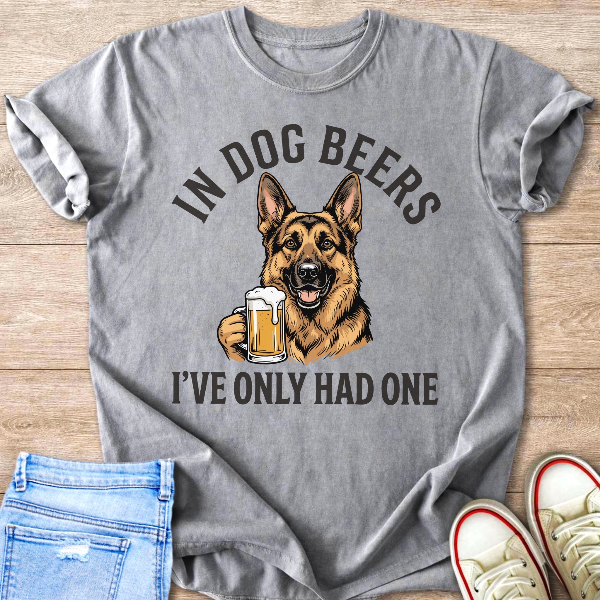 Grey t-shirt graphic of German Shepherd holding a beer mug, text reads "In Dog Beers I've Only Had One".