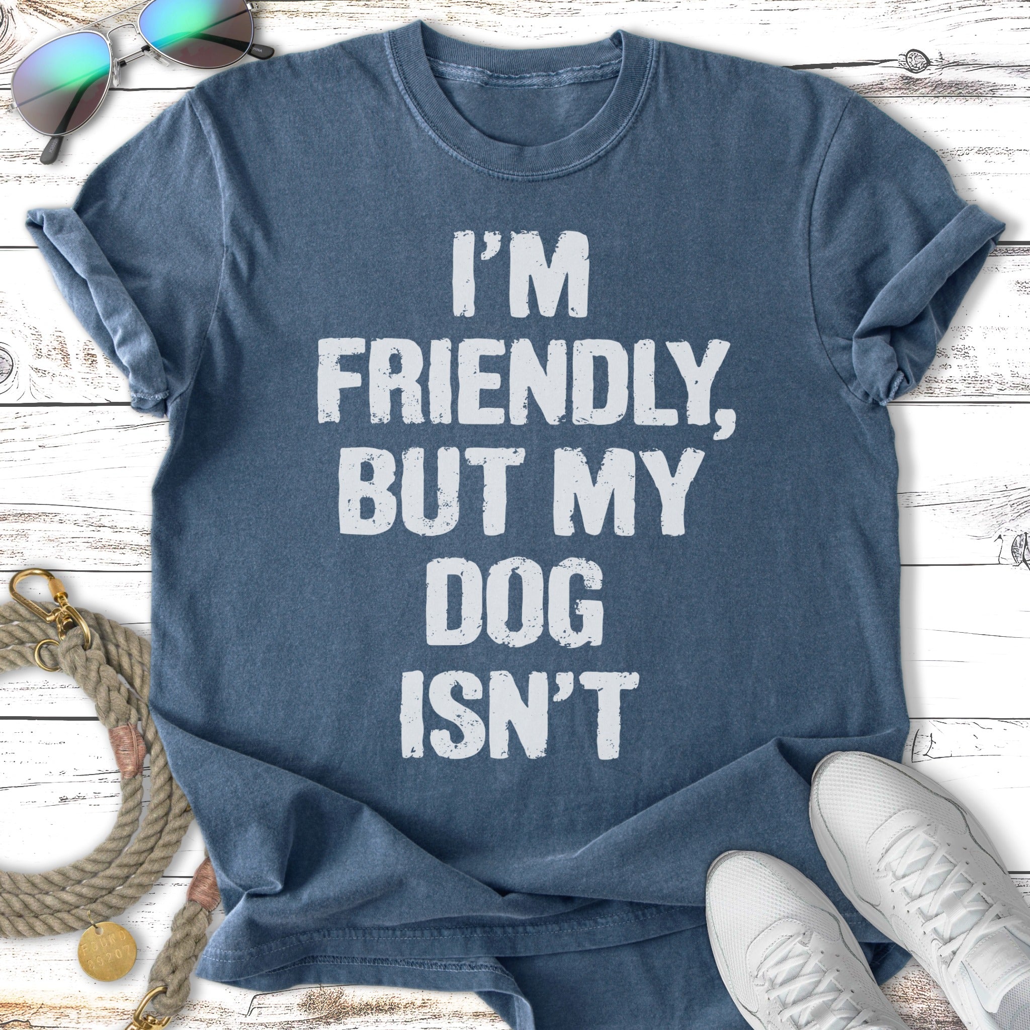 Dark blue t-shirt with white text "I'm friendly, but my dog isn't".