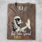 Cocker Spaniel dog wearing sunglasses gives a high-five on a brown t-shirt.