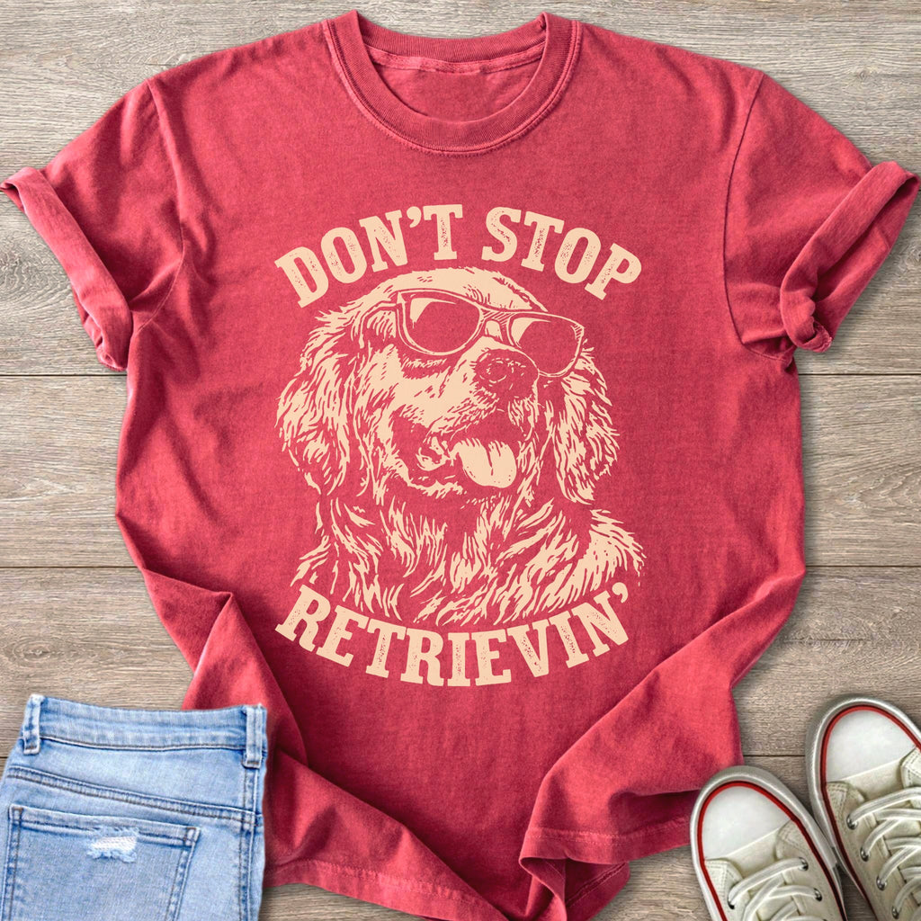 Red t-shirt with graphic of dog wearing sunglasses; text reads "DONT STOP RETRIEVIN".