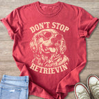 Red t-shirt with graphic of dog wearing sunglasses; text reads "DONT STOP RETRIEVIN".