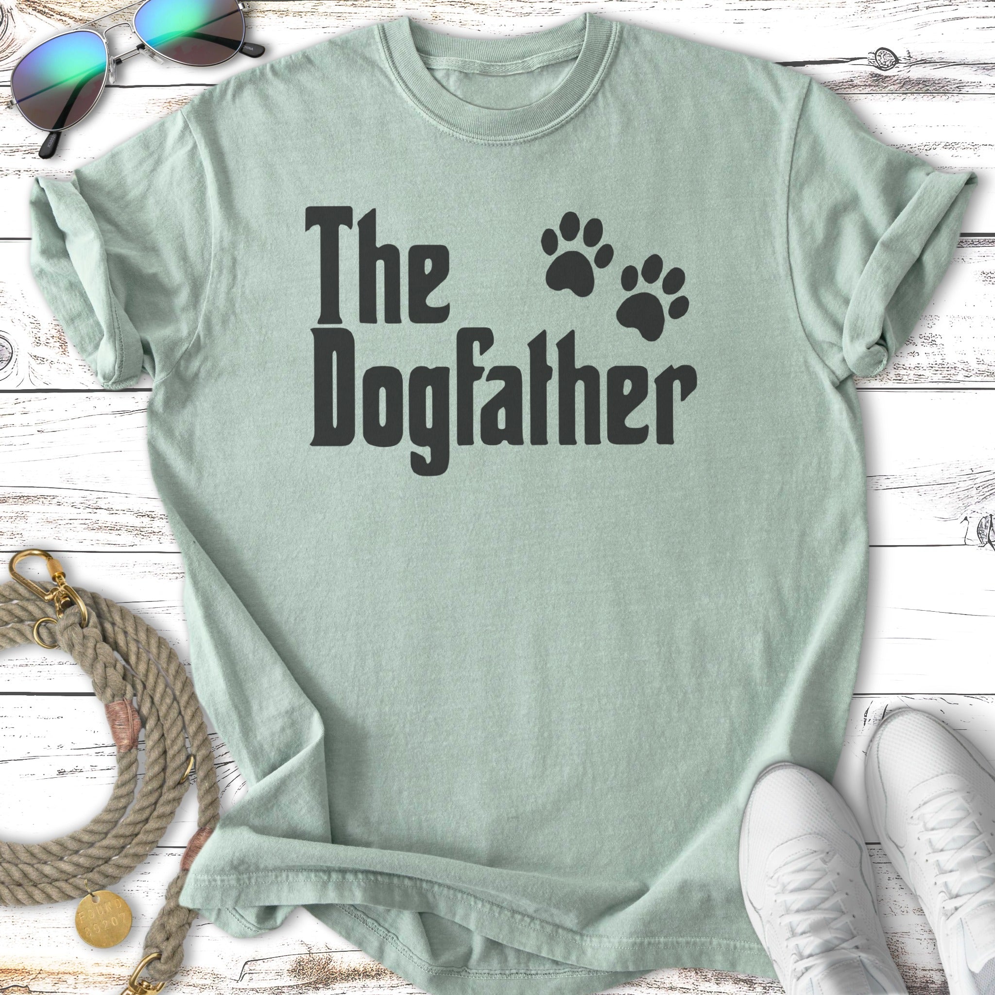Light mint green t-shirt with black text "The Dogfather" and paw prints.