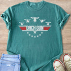 Teal t-shirt with white dachshunds and "DACH GUN" text in a badge design.