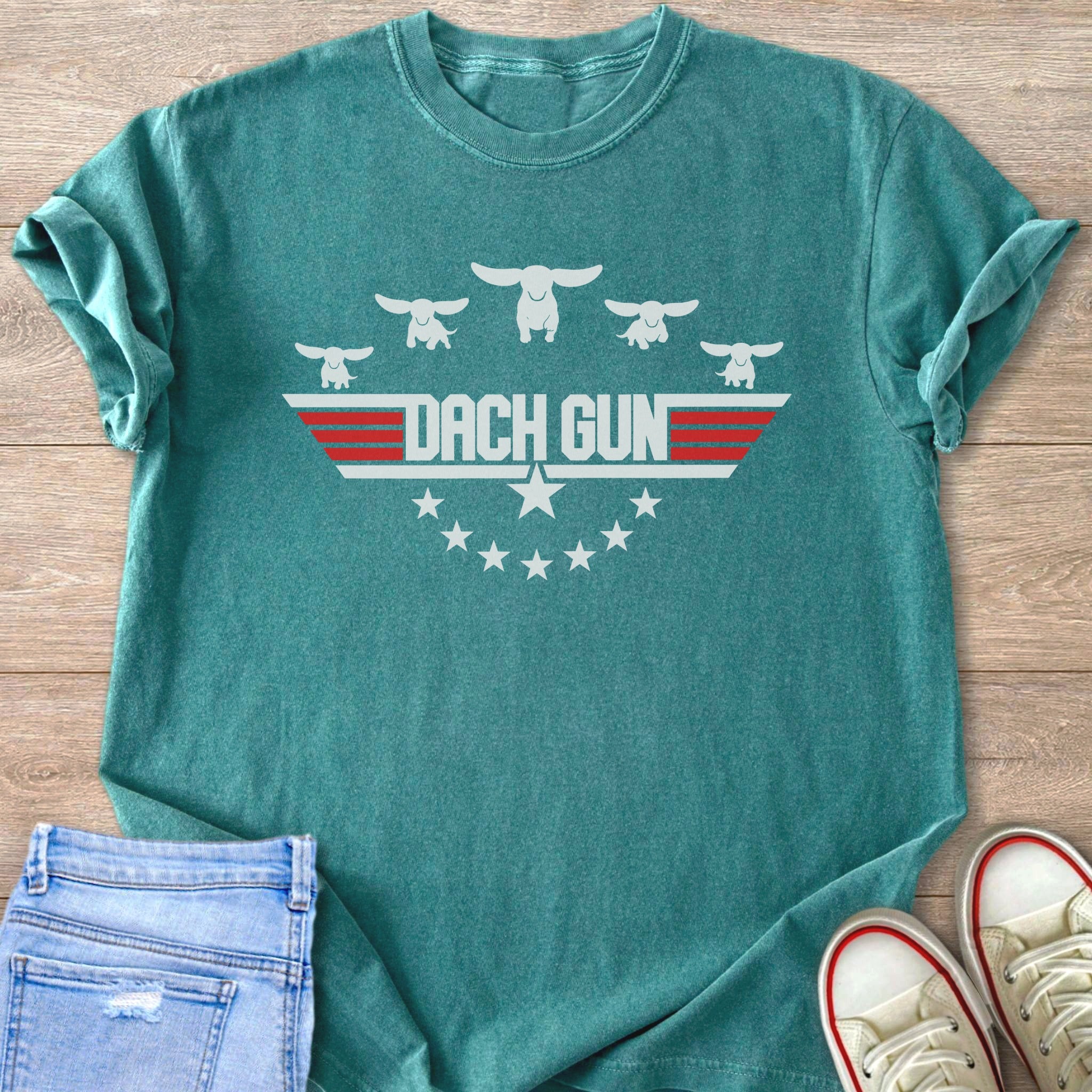 Teal t-shirt with white dachshunds and "DACH GUN" text in a badge design.
