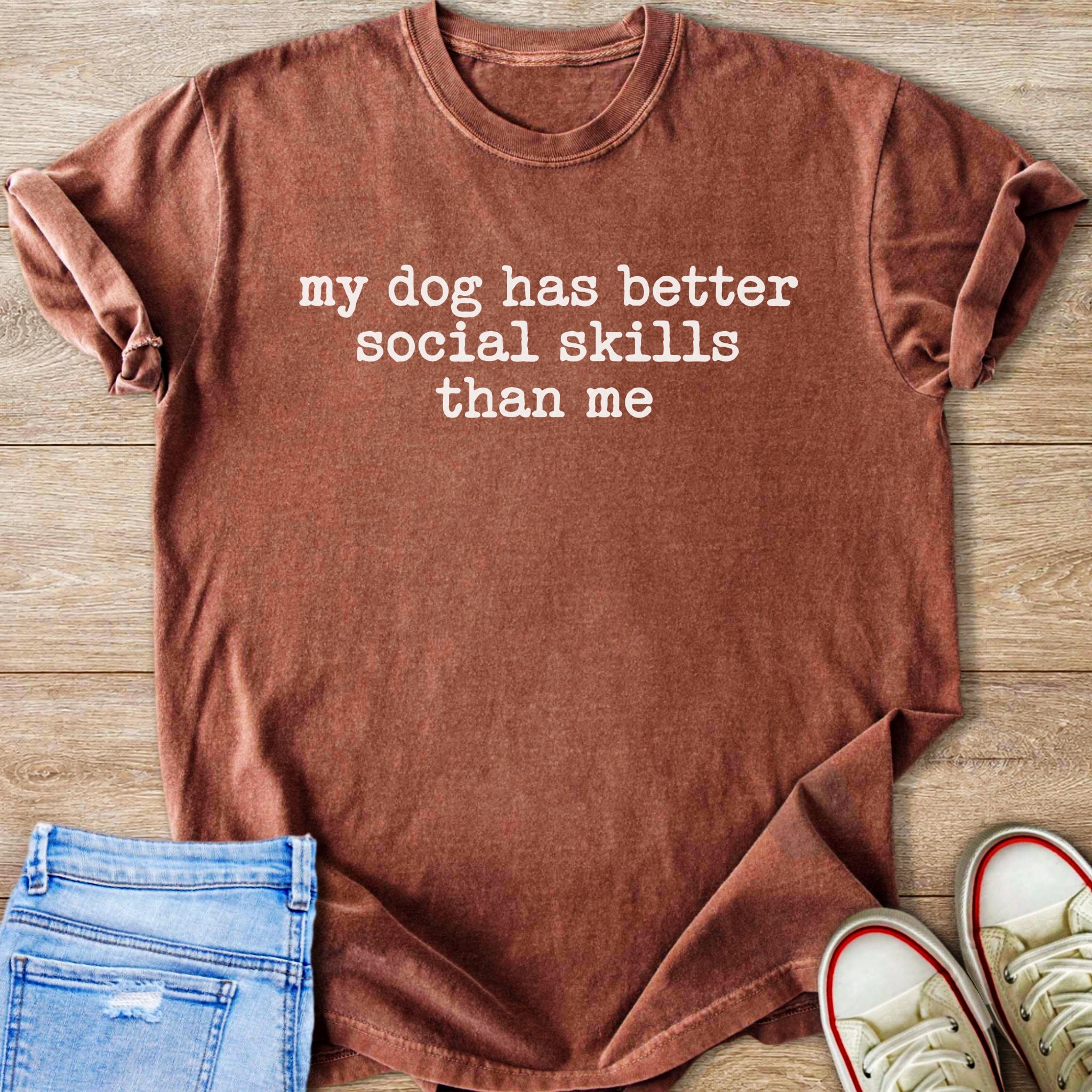 Brown t-shirt with white text "my dog has better social skills than me".
