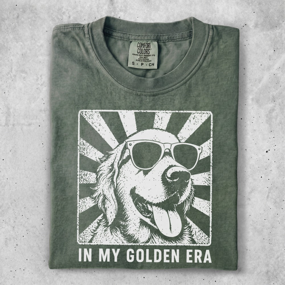 T-shirt with a white graphic of a golden retriever wearing sunglasses with radiating lines.