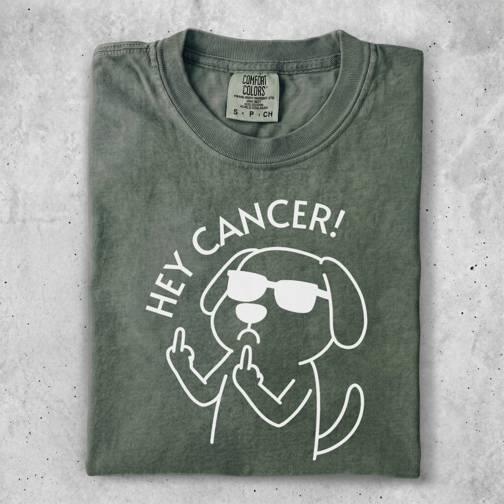Green t-shirt with dog graphic saying "Hey Cancer!" and flipping off middle finger.