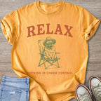 Orange t-shirt with text "RELAX" and a pug on a chair.