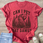 Red shirt with distressed graphic of bear in forest and text "CAN I PET DAT DAWG?".