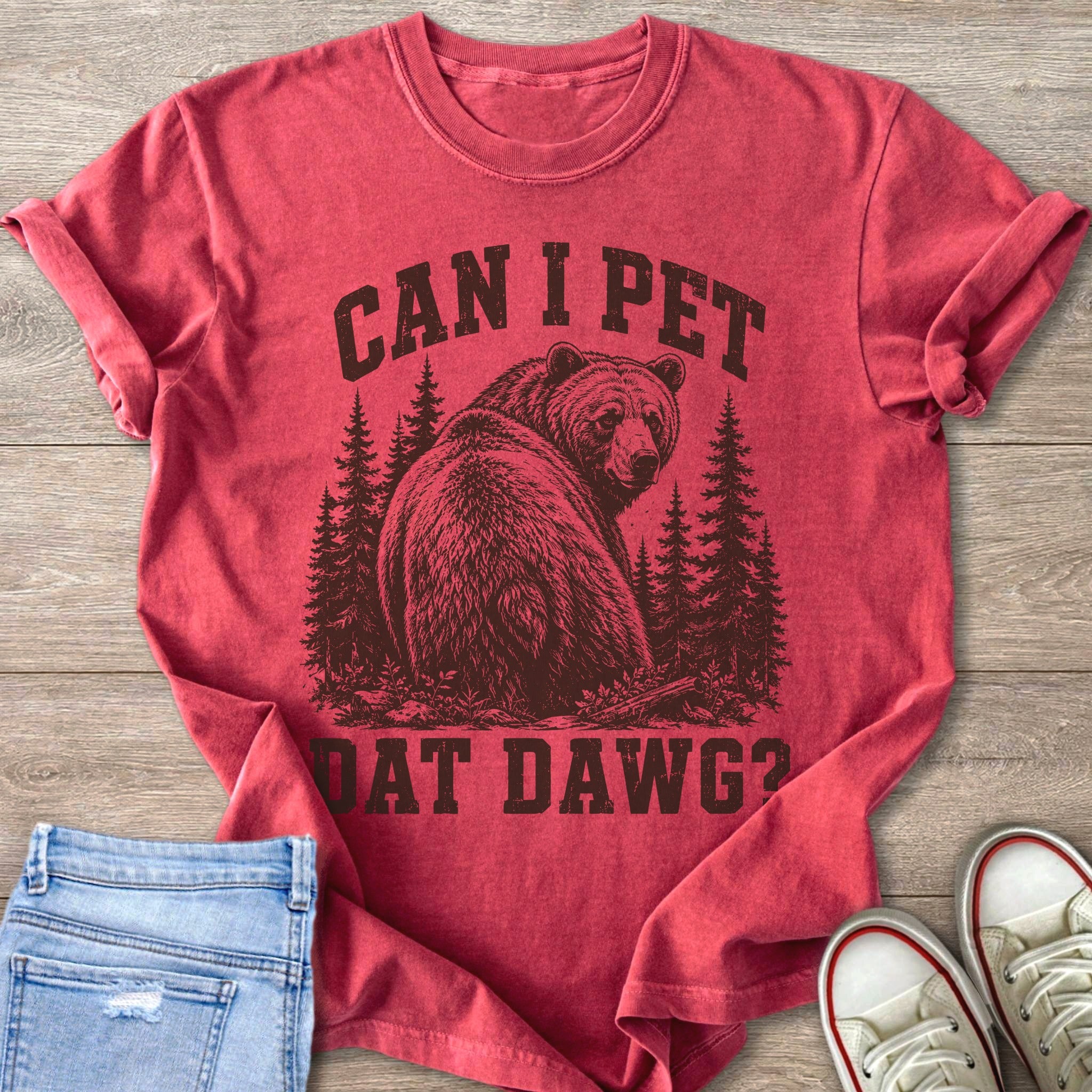 Red shirt with distressed graphic of bear in forest and text "CAN I PET DAT DAWG?".