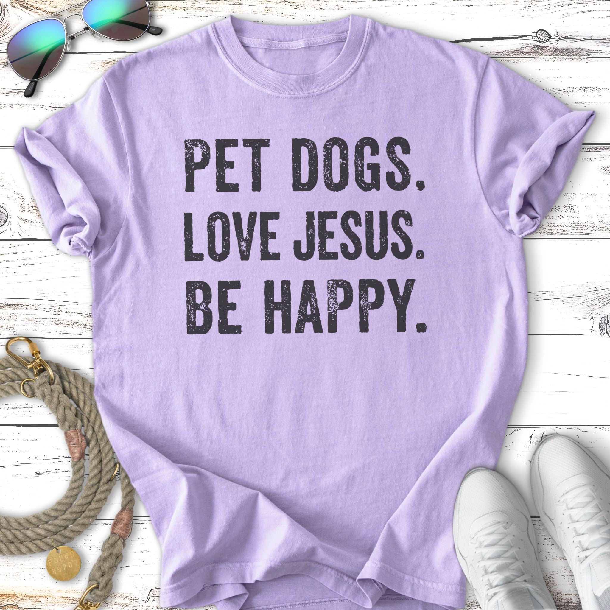 Lavender t-shirt with black text reading "PET DOGS. LOVE JESUS. BE HAPPY."