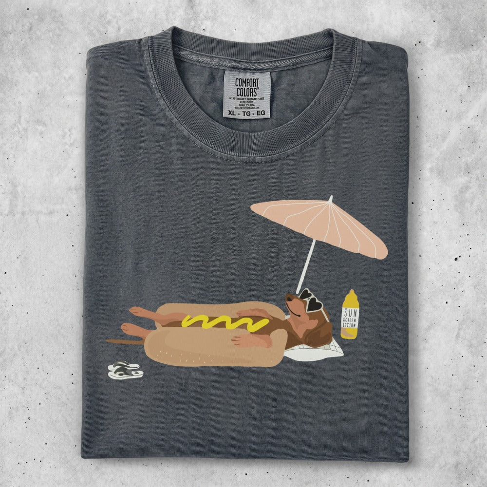 T-shirt with graphic of a hot dog on a beach umbrella.