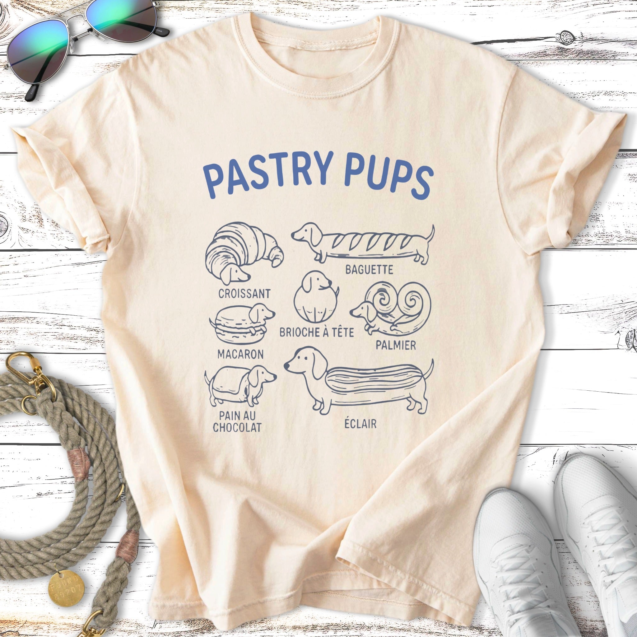 T-shirt with "Pastry Pups" title and illustrations of dog breeds as pastries.