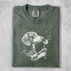 Green t-shirt with a white line drawing of a dachshund holding a dandelion.