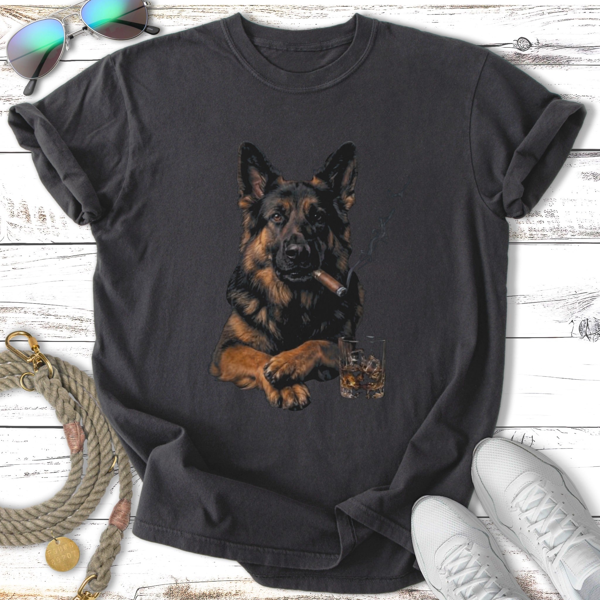 German Shepherd wearing sunglasses smoking cigar with whiskey on black t-shirt.