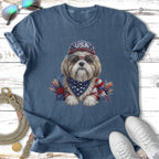 Dog wearing sunglasses and USA bandana, adorned with patriotic floral accents.