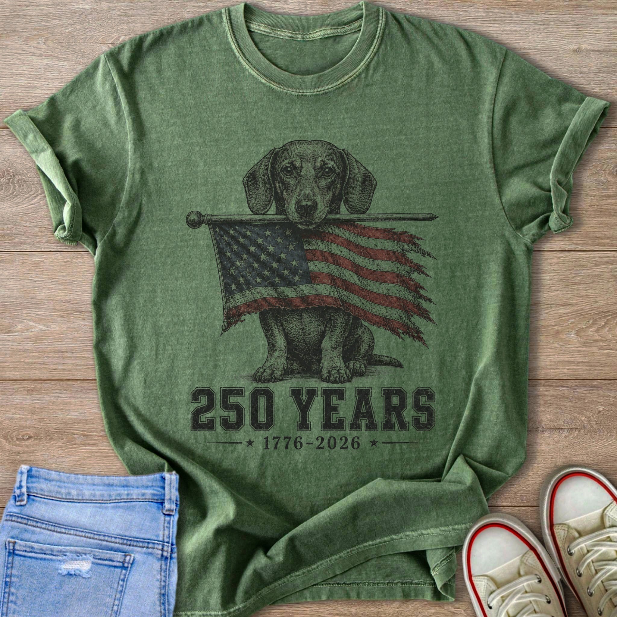 Dachshund holding tattered American flag with text "250 YEARS 1776-2026".