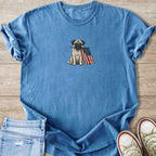 Pug holding an American flag in its mouth on a blue t-shirt.