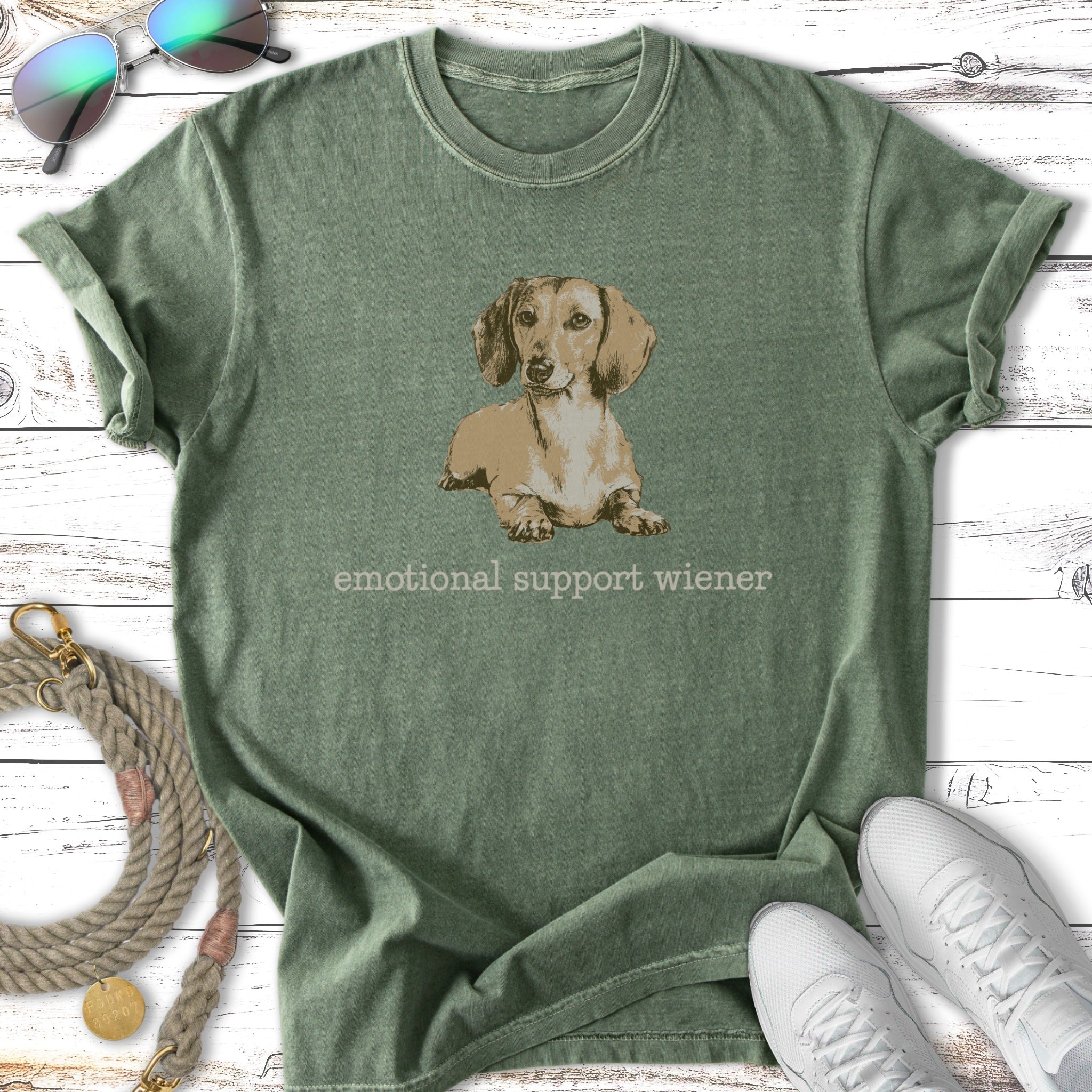 Green t-shirt with "emotional support wiener" text and dachshund illustration.