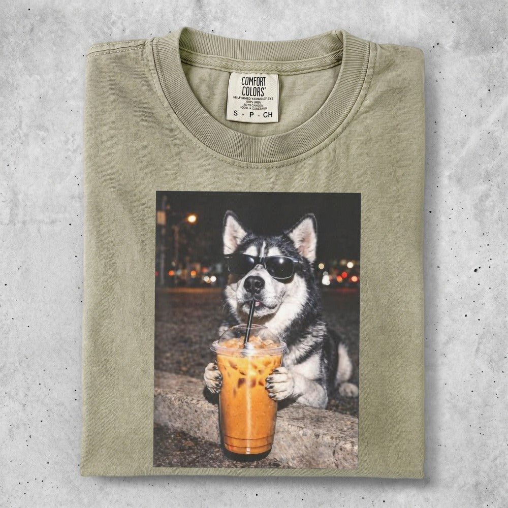 Husky wearing sunglasses holds an iced coffee drink.