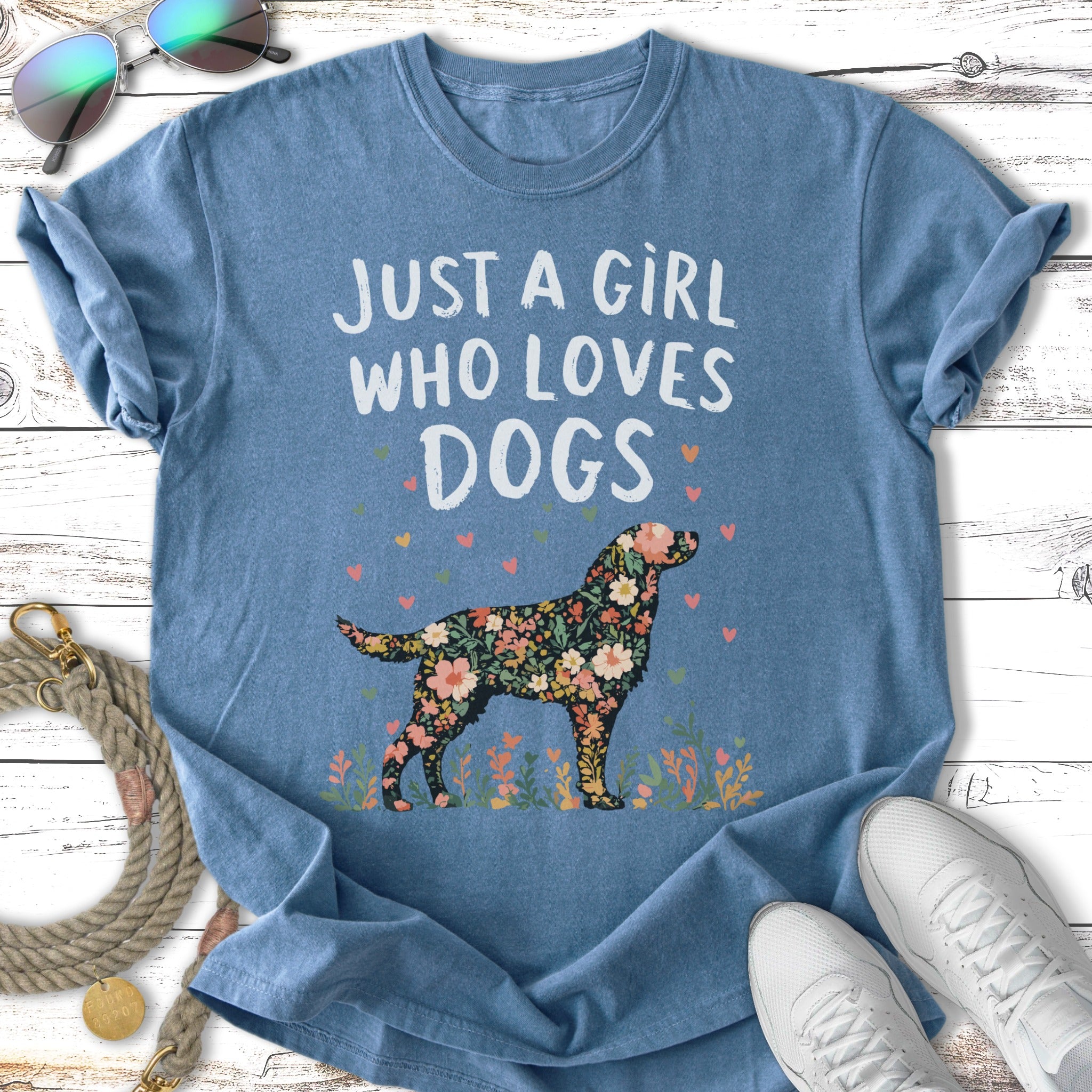 Floral dog silhouette with text "Just a girl who loves dogs" on blue t-shirt.
