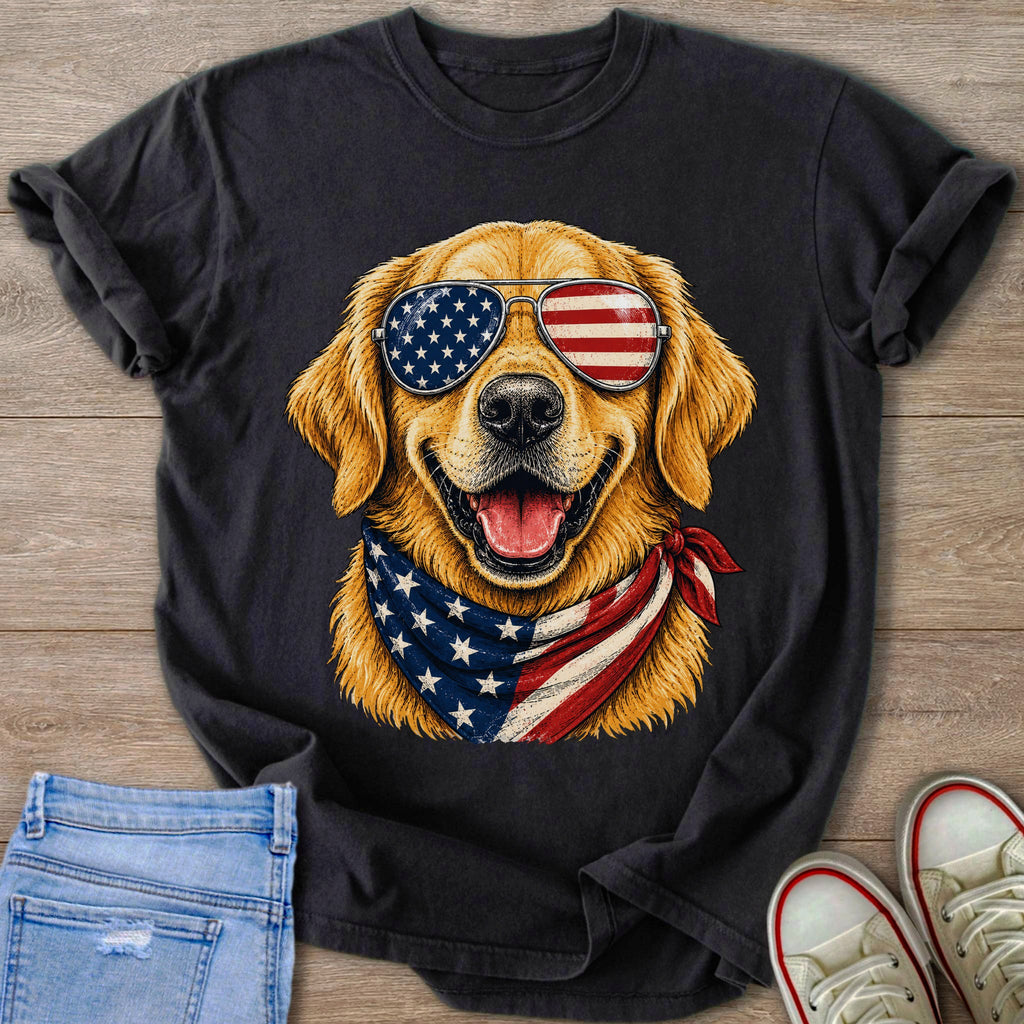 Golden retriever wearing American flag sunglasses and bandana on black t-shirt.