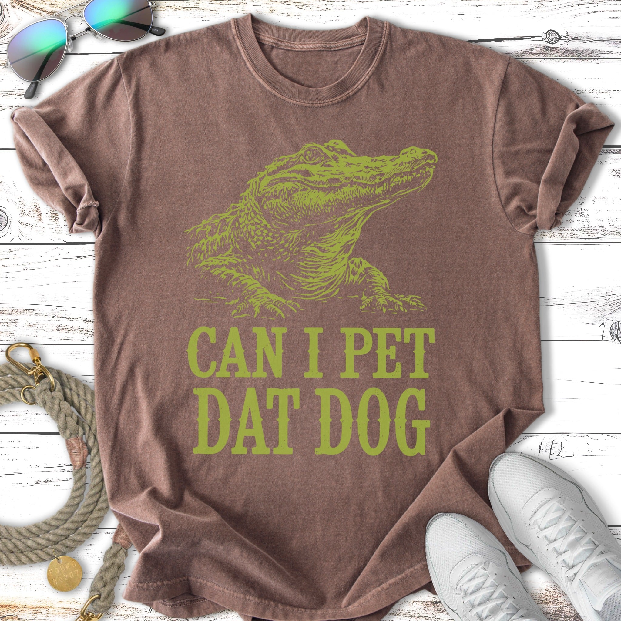 Green alligator graphic on brown t-shirt with "CAN I PET DAT DOG" text.
