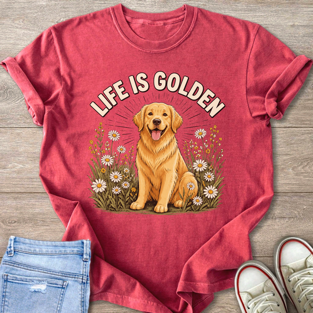 Golden Retriever dog with "LIFE IS GOLDEN" text in floral setting on a red t-shirt.