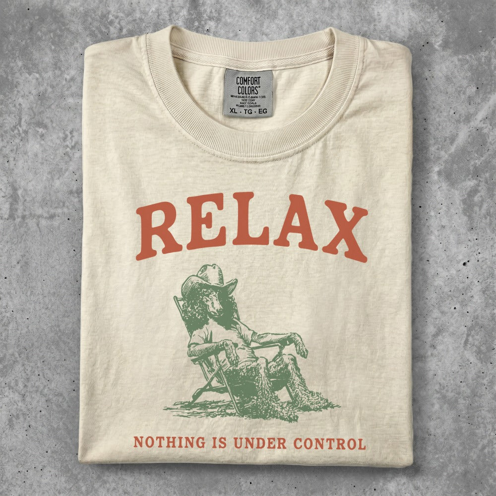 Cream t-shirt with "RELAX" and a person in a chair graphic.
