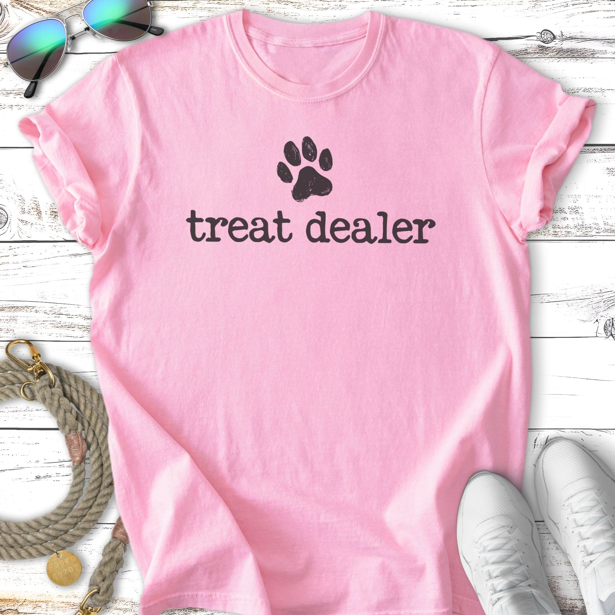 Pink t-shirt with "treat dealer" and a paw print in black.