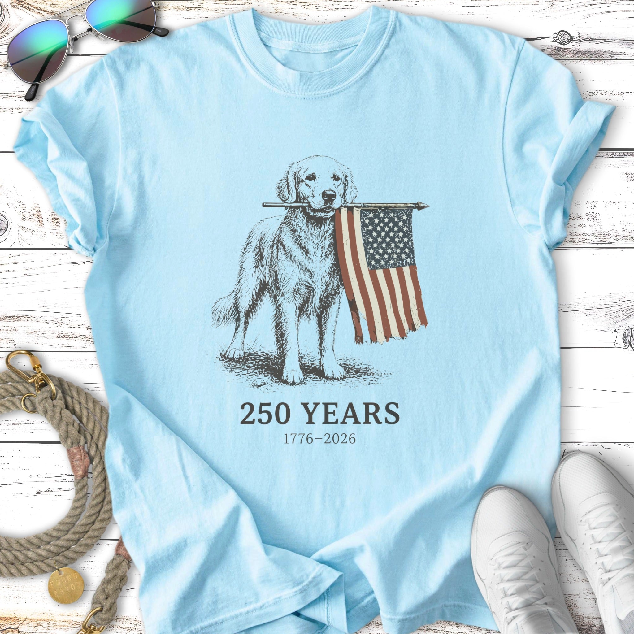 Golden retriever holding American flag, text "250 YEARS 1776-2026".