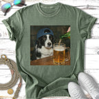 Border collie wearing a baseball cap pours a beer at a wooden table.