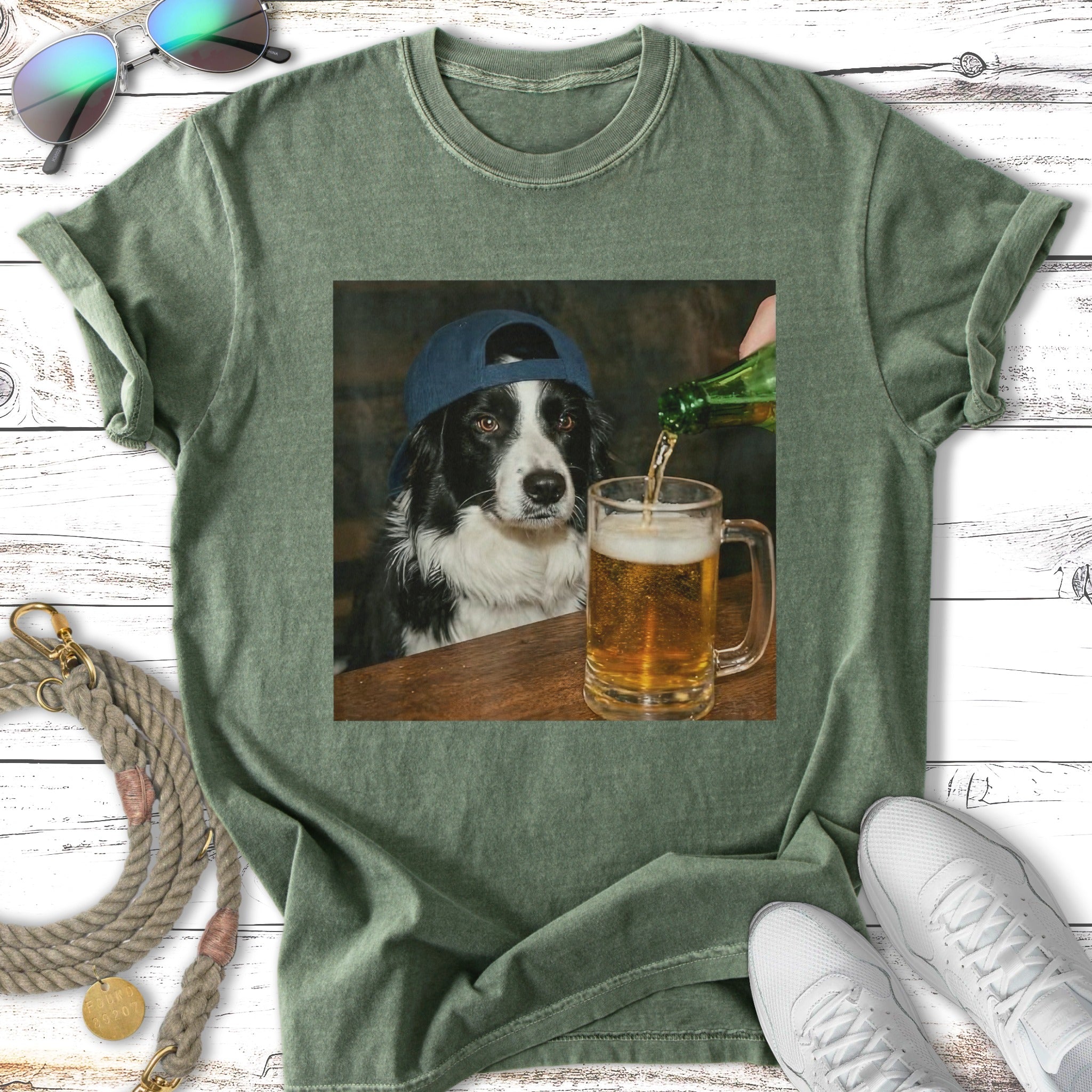Border collie wearing a baseball cap pours a beer at a wooden table.
