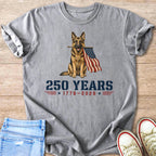 German Shepherd holding American flag with text "250 YEARS 1776-2026".
