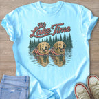Light blue t-shirt graphic with two golden retrievers in life vests and text "It's Lake Time".