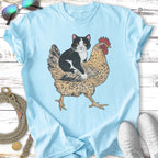T-shirt graphic of a black and white cat riding a chicken.