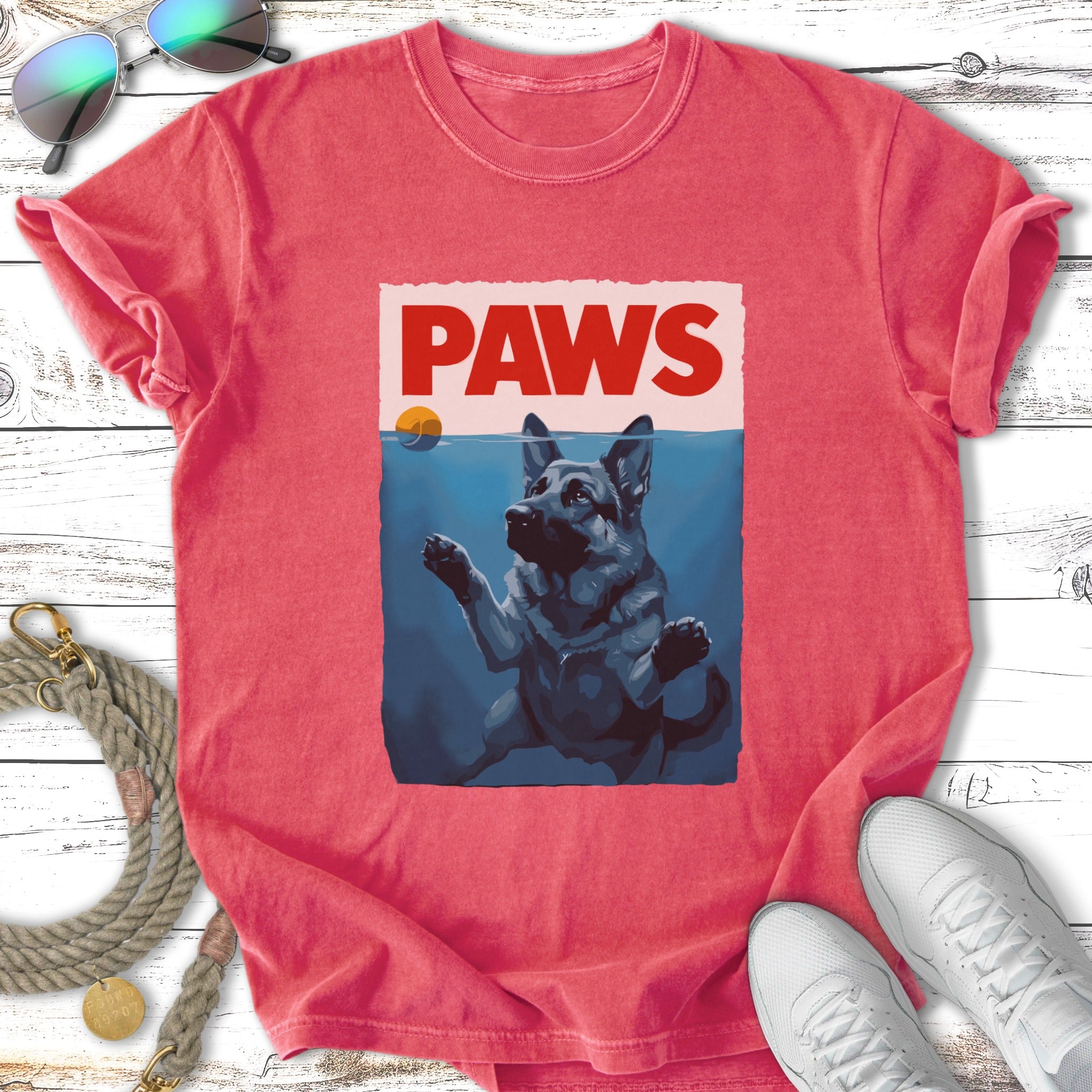 German Shepherd reaching out of water, "PAWS" title in red box.